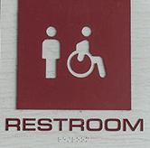 compliance sign for restroom red on gray wood
