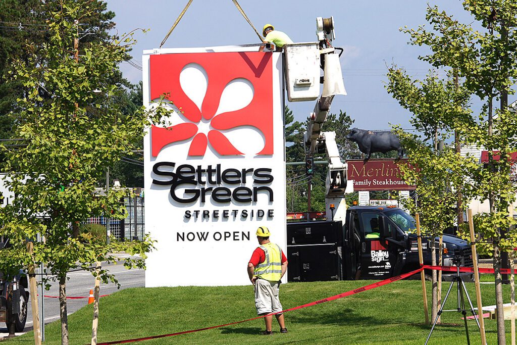outdoor installation of settlers green monument sign