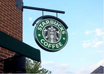 Installation of Starbucks Coffee blade sign on building exterior