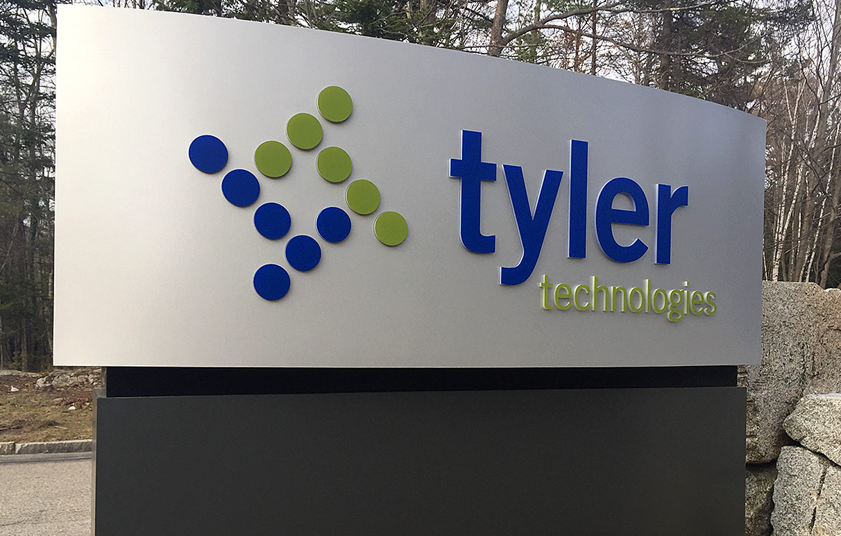 Script M Tylor Technologies internally lit moment sign.